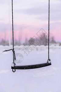 芬兰假日村Kuukiuru冬季秋千的雪和日落时间背景图片