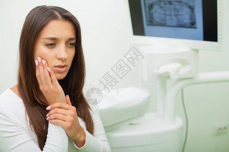 年轻女有牙痛在牙医面前烦恼的女人不图片