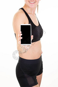 运动健身女手持带空白屏幕的智能手机复制粘贴运图片
