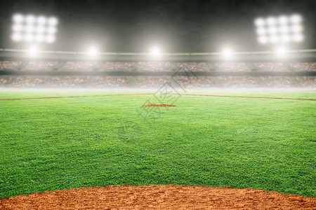在灯火通明的室外体育场的棒球场专注于背景和复制空间的图片