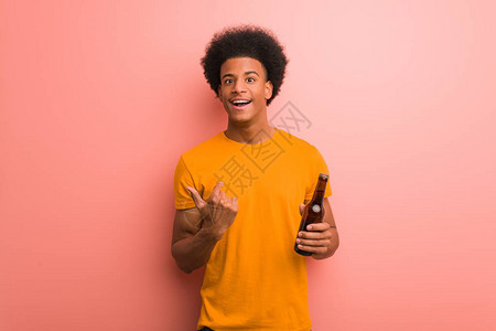 拿着啤酒的年轻非洲裔美国人惊讶感图片