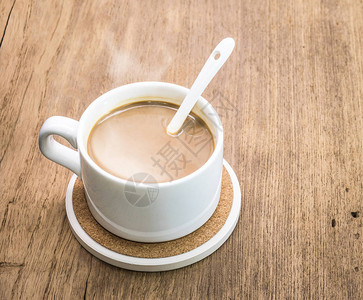 咖啡杯和木制背景上的饮料杯垫图片