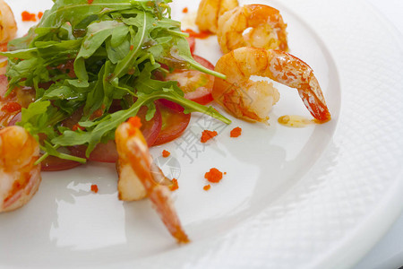 白色背景中的炸大虾生菜西红柿和红鱼子酱图片