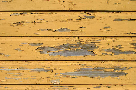 黄色的木制背景与剥落的旧油漆图片