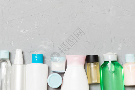 在水泥背景上配有化妆品和奶油瓶的平面成份带有复制空间的图片