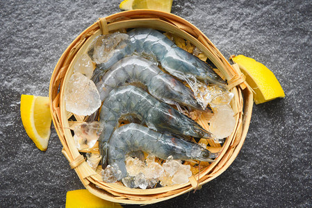 竹蒸汽船上的生虾和深盘餐馆或海产食品市场新鲜虾中背景图片