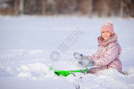 儿童骑车出去玩可爱的小女孩喜欢雪橇骑车孩子滑雪和在雪背景