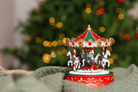 圣诞音乐玩具旋转木马在圣诞树燃烧的灯光的背景图片