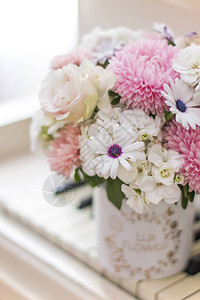 白色钢琴上一个漂亮的盒子里的花束紫菀绣球花和雏菊的花图片