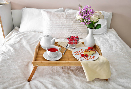 床上有美味早餐的托盘桌图片