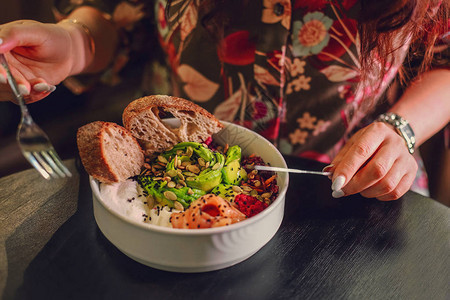 女人吃有机食品新鲜的海鲜食谱新鲜的鲑鱼戳碗图片