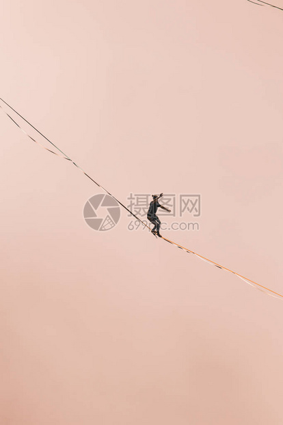 一个人沿着高在云层上方的拉长吊索行走highliner在峡谷中通过长而高的吊索拉力来保持平衡波斯尼亚和黑萨哥维图片