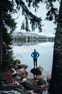 年轻男人独自站在湖边看风冬天清图片