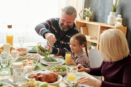 快乐爷在感恩节或家里的圣诞家庭晚宴期间用节日餐桌图片