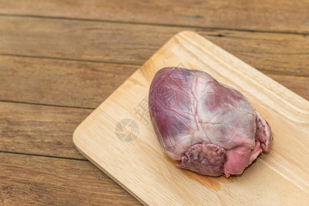 厨房木制切菜板上的新鲜猪心图片