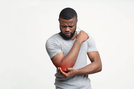 手肘关节有急疼痛的年轻Afro男子图片