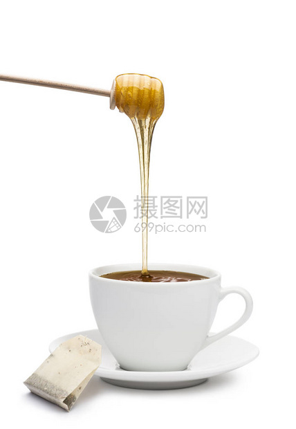 蜂蜜滴在茶杯中白图片