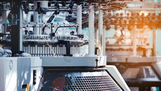 纺织品制造圆形针织面料纺织厂在纺纱生产线和旋转机械设备生产公司服装行业背景图片