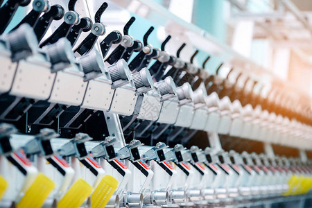 纺织品制造圆形针织面料纺织厂在纺纱生产线和旋转机械设备生产公司服装行业背景图片
