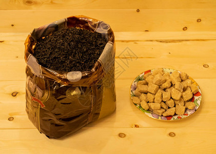 木制背景上的大袋茶和糖图片