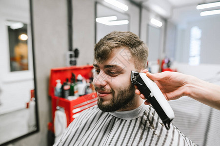 快乐的客户用明亮的男打击乐剪头发图片