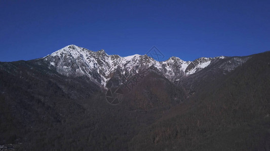 风雪的景象覆盖了蓝色明天背景的山脉图片