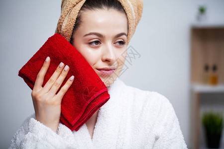 可爱的女人洗完澡后擦脸巾图片