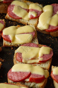新鲜的三明治配奶酪和香肠热三明治在砧板上加香肠和硬图片