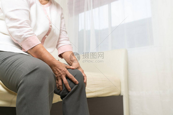 老年妇女在家里的膝痛老年概念图片