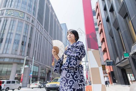 亚裔日语妇女穿着日本传统服装到城图片