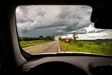 巴西一片绿地和厚云的沥青道路的驱动器图片