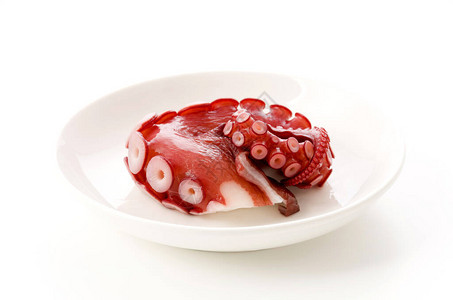 白盘子上的煮章鱼腿图片