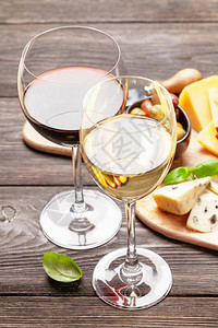奶酪肉类葡萄和橄榄前的红酒杯和白图片
