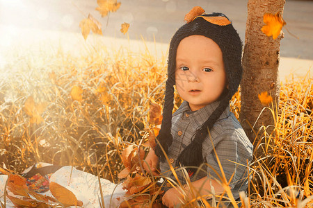 秋季喜悦的甜混合式男孩近距离观看编织帽的可爱甜蜜和图片