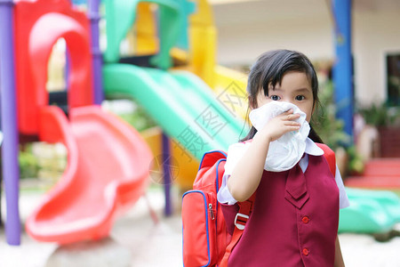 亚洲儿童学生或小女孩因流感和沙尘天气中的弱或和细菌而在幼儿园学龄前因鼻子打喷嚏和手帕面罩上感图片