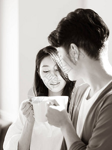 家里的年轻亚洲女人和男人用黑白手图片
