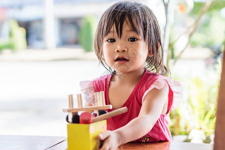 亚洲女婴玩木块玩具的肖像图在木桌上2岁的孩子孩子概念的学习和发展图片
