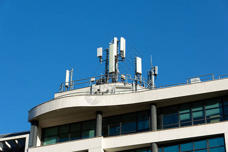 5G和4G移动电话天线安装在大楼屋顶背景图片