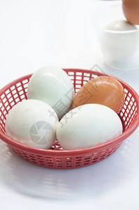 盐蛋和鸡蛋放在塑料篮子里在wh背景图片