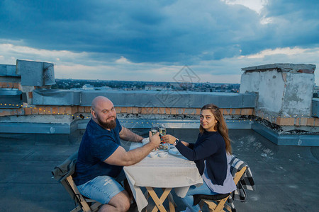 屋顶上的恋人坐在桌旁图片