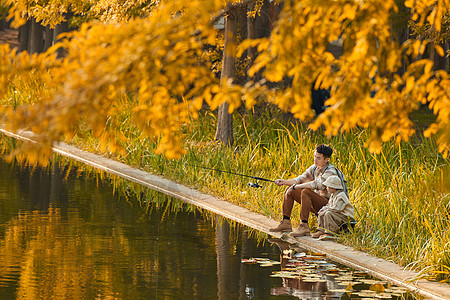 秋天在河在公园湖边钓鱼的父子背景
