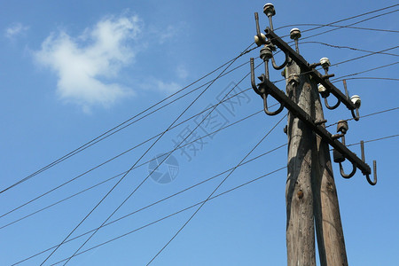 蓝天下的旧木电桅杆图片
