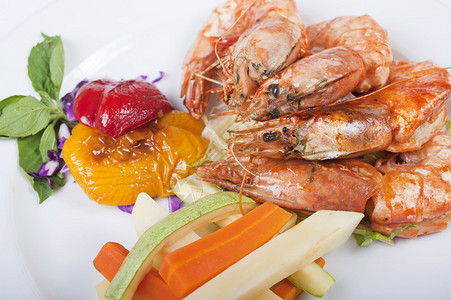 白盘上的虎虾和蔬菜点图片