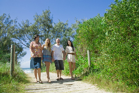 家庭在海滩上走来去图片