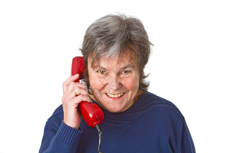 拥有电话接听器的女老年人图片