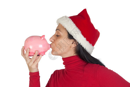 圣诞女孩亲吻小猪银行孤图片