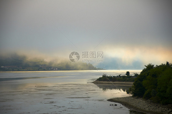 早晨在河的日出反射薄雾图片