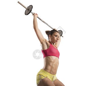 用杠铃做高强度锻炼的肌肉女图片