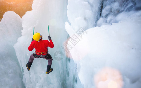一名年轻的登山者在攀冰和寒冷天气下冬季体图片