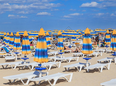 黑海岸蓝色清澈的海水沙滩遮阳伞和日光浴床保加图片